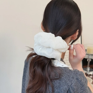 Elegant white mesh pleated scrunchie hair tie shown on a model for a chic look