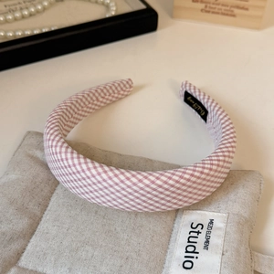 Detailed close-up of pink and white gingham checkered sponge headband with fabric texture