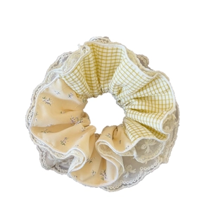 Lace-edged plaid scrunchie in yellow floral and checkered fabric for bun hairstyles