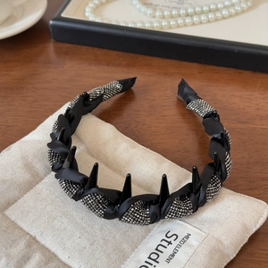 Detail of black silk headband featuring sparkling silver rhinestones and inner fixing teeth