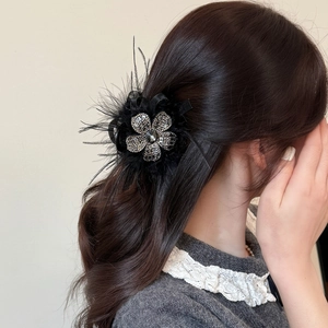 Elegant black feather hair claw clip with crystal flower detail for women's hairstyles