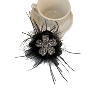 Elegant black feather hair claw clip with sparkling rhinestones and floral design