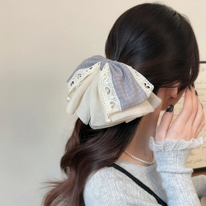 Elegant lavender plaid lace bow hair clip with pearl pendant shown on hair