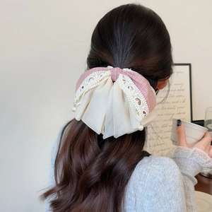 Elegant pink plaid lace bow hair clip with pearl pendant shown on model's hairstyle