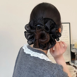 Elegant oversized black mesh scrunchie with glitter dots shown on a bun hairstyle