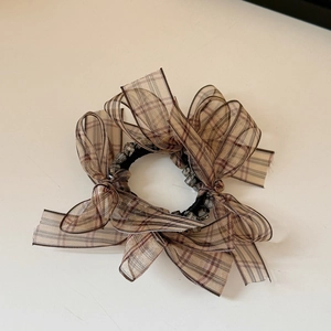 Detail of Korean plaid bow hair tie featuring organza ribbon and crystal bead charm
