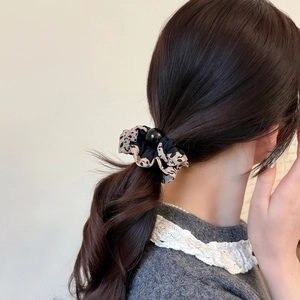 Elastic leopard print and black scrunchie with round bead on ponytail holder