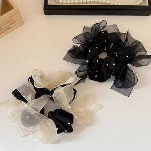 Elegant mesh dot scrunchies with bow and pearl details in black and champagne colors