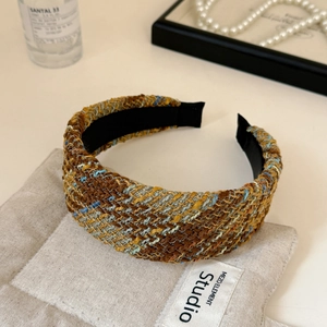 Macro shot of multi-color tweed knitted wide headband with premium woven texture