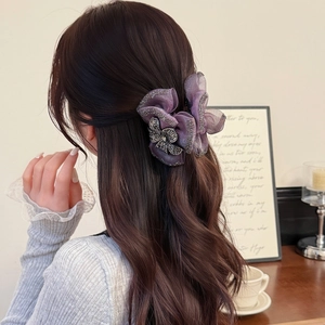 Elegant purple mesh bow hair claw clip with rhinestones shown in a semi-tied hairstyle