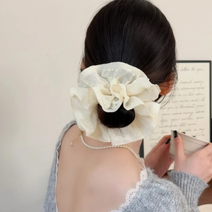 Elegant off-white organza scrunchie with pearls for a sophisticated low bun hairstyle