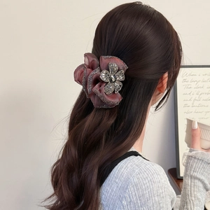 Elegant mauve organza flower hair claw with rhinestones for a sophisticated half-up hairstyle
