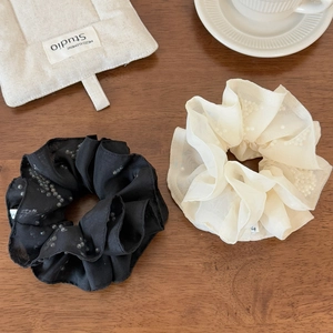 Elegant organza scrunchies with white pearls in black and beige on wooden surface