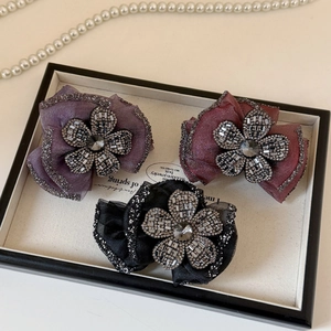 Sparkling rhinestone flower bow hair clips with tulle layers in purple, red, and black colors