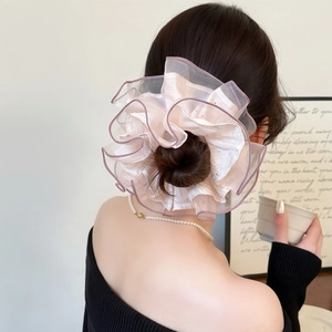Oversized organza scrunchie in light pink with purple ruffled edges on hair