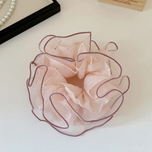 Detail of pink organza scrunchie featuring delicate purple stitching and tiny rhinestone beads