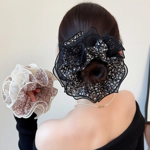 Floral print mesh oversized scrunchies in black and beige displayed on a bun hairstyle