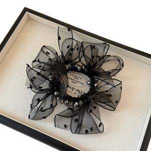 Elegant black mesh lace scrunchie with polka dots and beaded accents in a white gift box