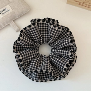 Close-up of black and white plaid scrunchie with wave edges for messy bun hairstyles