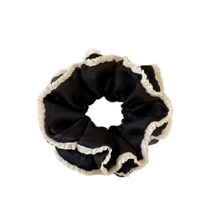 Chiffon scrunchie in candy black with white pleated lace trim for a sweet spring look