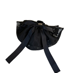 Elegant black bow hair clip with decorative pearls and long ribbons for women