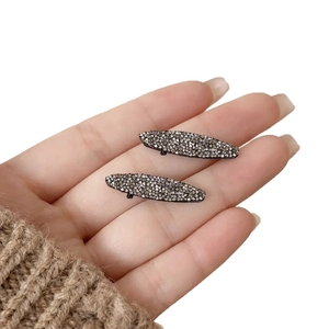 Elegant pair of oval hair clips with grey rhinestones on black alloy base