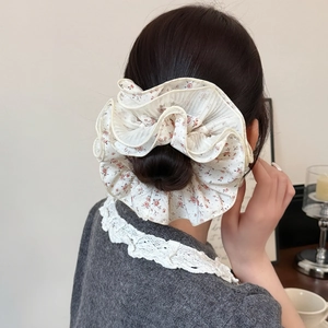 Korean style floral lace scrunchie with layered ruffles for elegant bun hairstyles