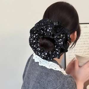 French retro oversized black floral lace hair scrunchie shown on a classic bun hairstyle