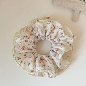 Detail of Korean floral lace scrunchie with cream layers and pink flower patterns