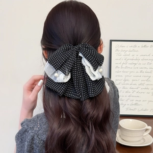 Elegant black polka dot bow hair clip with white lace and pearl detail for women