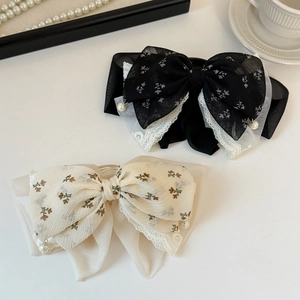 French floral lace bow hair clips in black and cream with elegant pearl accents