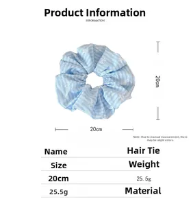 Detail of light blue striped fabric scrunchie with white bow pattern and 20cm size mark