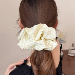 Elegant large yellow checkered scrunchie with jacquard dots shown on ponytail hairstyle