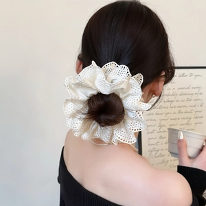 Elegant white lace oversized scrunchie hair tie styled on a messy bun hairstyle