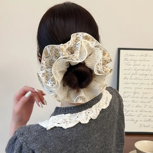 Floral chiffon scrunchie with layered pleats for a voluminous bun hairstyle look