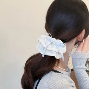 French lace scrunchie with blue polka dots and pearl bow worn on a ponytail