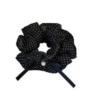 French polka dot bow hair scrunchie with a central white pearl pendant on white background