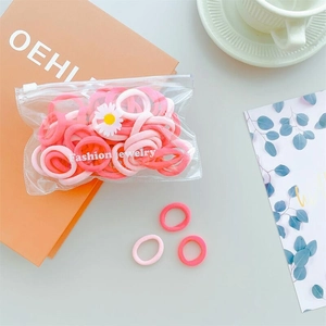Close-up of colorful elastic hair bands with a daisy charm in a minimalist lifestyle setting