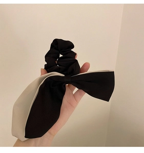 Close-up of dual-layer chiffon bow scrunchie with elegant black and white contrast