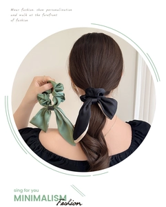 Detailed view of satin bow hair scrunchies in black and dark green with metal buckle