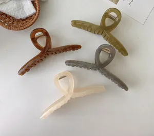 Set of four large matte hair claws in translucent olive, amber, grey and cream colors