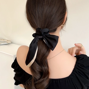 Elegant black satin double bow hair tie Scrunchie with beige trim shown on model