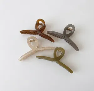 Set of four large matte geometric hair claws in brown, grey, cream, and olive green