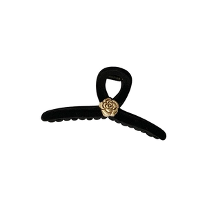Elegant black velvet claw clip featuring a gold camellia rose for French vintage hairstyles