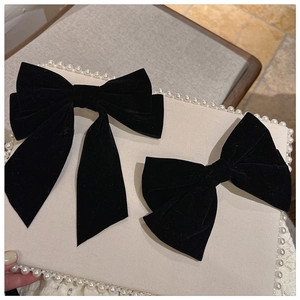 Detail view of vintage black velvet bow hair clips with soft texture and elegant design