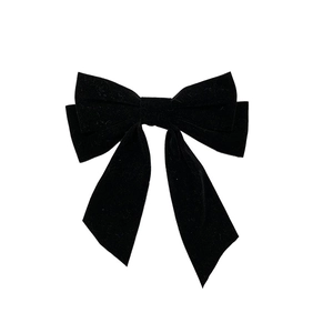 Elegant vintage black velvet double bow hair clip with long streamers on white background