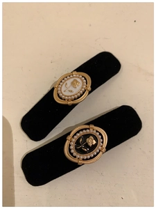 Detail of vintage black velvet hair clips with rose design and pearl embellishments