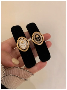 Detail of vintage French style black velvet hair clips with gold rose and pearl inlay