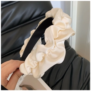 Elegant cream pleated headband made of soft satin fabric for stylish hair styling