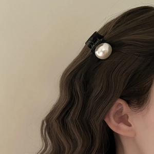 French vintage mini pearl hair claw clip for elegant side bangs styling on brown wavy hair